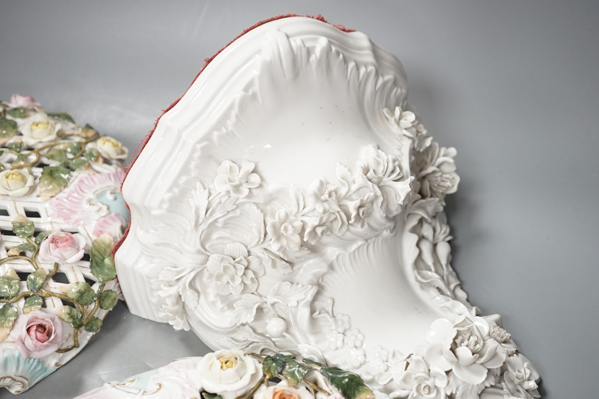 Two Sitzendorf porcelain ceiling shades, a similar wall bracket and a Dresden white glazed wall bracket, shades 30cm diameter